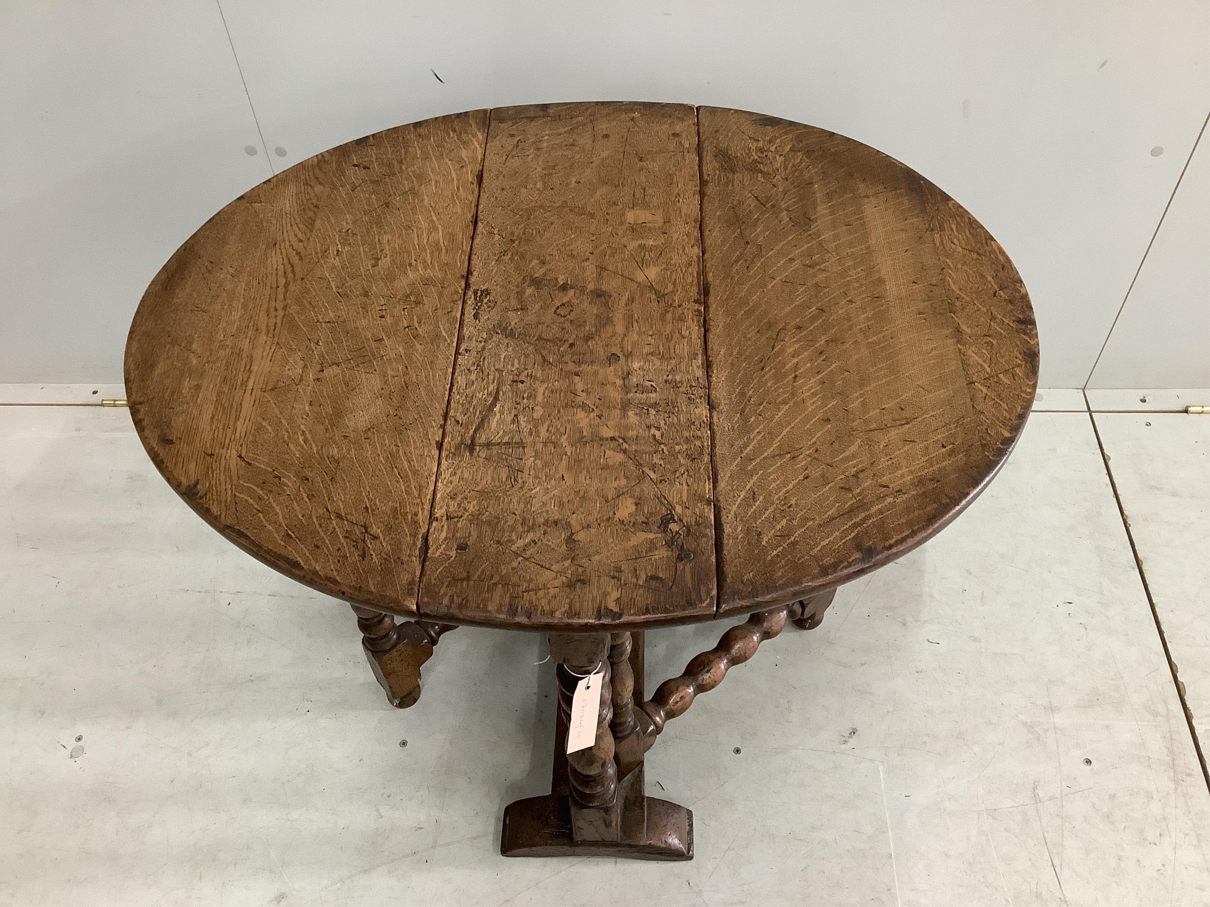 A small 17th century style oak gateleg occasional table, width 65cm, depth 26cm, height 65cm. Condition - fair to good